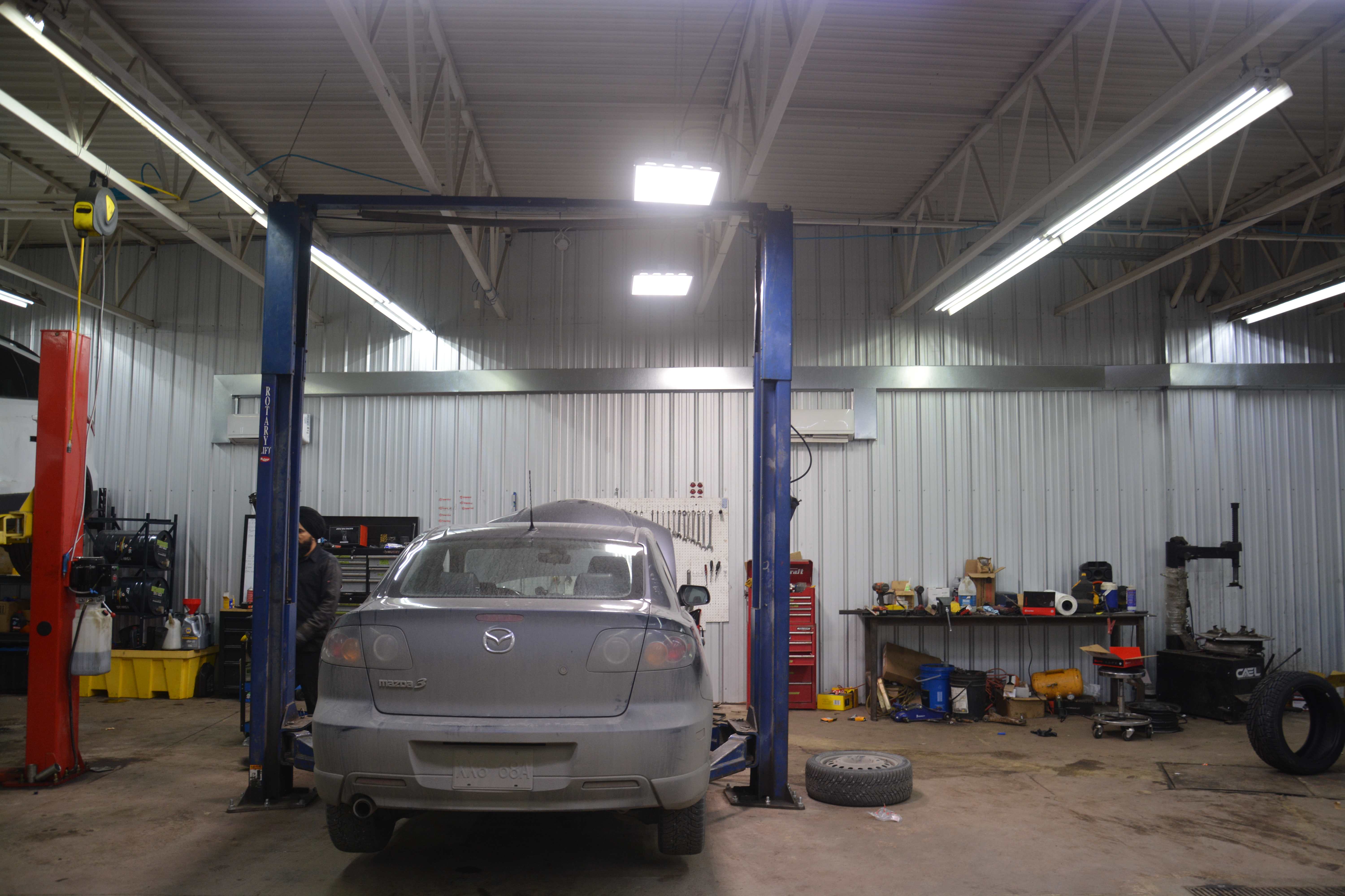 Full workshop view with vehicle on lift